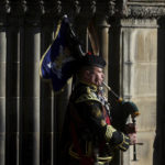 
              A piper plays outside St. Giles Cathedral, in Edinburgh, Scotland, Tuesday, Sept. 13, 2022. King Charles III and Camilla, the Queen Consort, flew to Belfast from Edinburgh on Tuesday, the same day the queen’s coffin will be flown to London from Scotland. (Kai Pfaffenbach/Pool Photo via AP)
            