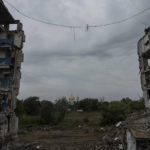 
              A church can be seen in the distance through an apartment building destroyed by an airstrike in the recently retaken area of Izium, Ukraine, Thursday, Sept. 15, 2022. (AP Photo/Evgeniy Maloletka)
            