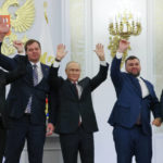 
              From left, Moscow-appointed head of Kherson Region Vladimir Saldo, Moscow-appointed head of Zaporizhzhia region Yevgeny Balitsky, Russian President Vladimir Putin, center, Denis Pushilin, the leader of the Donetsk People's Republic and Leonid Pasechnik, leader of self-proclaimed Luhansk People's Republic wave during a ceremony to sign the treaties for four regions of Ukraine to join Russia, at the Kremlin, Moscow, Friday, Sept. 30, 2022. The signing of the treaties making the four regions part of Russia follows the completion of the Kremlin-orchestrated "referendums." (Mikhail Metzel, Sputnik, Kremlin Pool Photo via AP)
            