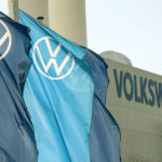 
              FILE - In this file photo dated April 23, 2020, company logo flags wave in front of a Volkswagen factory building in Zwickau, Germany. Volkswagen has set the price range for the multibillion-euro sale of a minority stake in luxury brand Porsche as its prepares an initial public offering to fund VW's investments in new technologies and businesses including electric cars, software and services. (AP Photo/Jens Meyer, File)
            