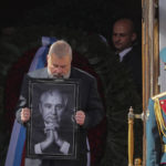 
              Nobel Peace Prize awarded journalist Dmitry Muratov carries a portrait of the late former Soviet president Mikhail Gorbachev after a farewell ceremony at the Pillar Hall of the House of the Unions in Moscow, Saturday, Sept. 3, 2022. (Maxim Shipenkov/Pool Photo via AP)
            