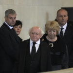 
              President of Ireland Michael D Higgins, centre, and his wife Sabina, second right, pay their respects as they file past the coffin of Queen Elizabeth II, draped in the Royal Standard with the Imperial State Crown and the Sovereign's orb and sceptre, lying in state on the catafalque in Westminster Hall, at the Palace of Westminster, in London, Sunday, Sept. 18, 2022, ahead of her funeral on Monday. (AP Photo/Markus Schreiber, pool)
            