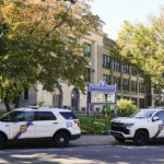 
              Police vehicles are parked at Roxborough High School near where multiple people were shot in Philadelphia, Wednesday, Sept. 28, 2022. Authorities have identified the 14-year-old youth killed in a shooting on Tuesday that also wounded several other teens as they walked away from a Philadelphia high school athletic field after a football scrimmage.  (AP Photo/Matt Rourke)
            