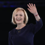 
              Liz Truss waves on stage after a Conservative leadership election hustings at Wembley Arena in London, Wednesday, Aug. 31, 2022. Britain's Prime Minister Boris Johnson announced his resignation in early July. His Conservative Party is set to announce his successor on Monday. (AP Photo/Kirsty Wigglesworth)
            