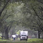 
              Residents walk through a neighborhood with fallen branches and leaves in the aftermath of Hurricane Ian, Thursday, Sept. 29, 2022, in Orlando, Fla. (AP Photo/Phelan M. Ebenhack)
            