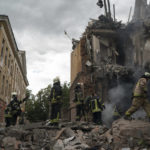 
              Firefighters work to extinguish a fire as they look for potential victims after a Russian attack that heavily damaged a residential building in Sloviansk, Ukraine, Wednesday, Sept. 7, 2022. (AP Photo/Leo Correa)
            