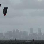 Kite surfers take advantage of strong winds caused by distant Hurricane Ian, at Matheson Hammock Park in Coral Gables, Fla. Tuesday, Sept. 27, 2022. Miami's skyline is seen in the background. (AP Photo/Rebecca Blackwell)