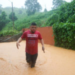 
              BEST QUALITY AVAILABLE - A man walks on a road flooded by Hurricane Fiona in Cayey, Puerto Rico, Sunday, Sept. 18, 2022. (AP Photo/Stephanie Rojas)
            
