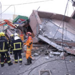 
              In this photo provided by Hualien City Government, firefighters are seen at a collapsed building during a rescue operation following an earthquake in Yuli township, Hualien County, eastern Taiwan, Sunday, Sept. 18, 2022. A strong earthquake shook much of Taiwan on Sunday, toppling at least one building and trapping two people inside and knocking part of a passenger train off its tracks at a station.(Hualien City Government via AP)
            