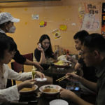 
              Customers at the Yume Wo Katare restaurant enjoy the fatty, garlicky Jiro-style "ramen" noodle in Beijing, Sunday, Sept. 11, 2022. Friend or foe? Or both? On the streets of Tokyo and Beijing, the ties between Japan and China remain complicated and often contradictory, 50 years after the two countries normalized relations as part of a process that brought communist China into the international fold. (AP Photo/Ng Han Guan)
            
