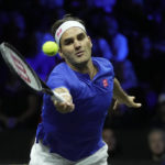 
              Team Europe's Roger Federer returns the ball as he and Rafael Nadal play in a Laver Cup doubles match against Team World's Jack Sock and Frances Tiafoe at the O2 arena in London, Friday, Sept. 23, 2022. (AP Photo/Kin Cheung)
            