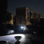 
              An employee uses a flashlight as she checks if windows from a hotel building were damaged after strong explosions have been heard following a Russian attack in Pokrovsk, Ukraine, Saturday, Sept. 10, 2022. (AP Photo/Leo Correa)
            