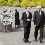 
              Israeli President Isaac Herzog, left, and German President Frank-Walter Steinmeier, right, attend a wreath laying ceremony at the Holocaust memorial in Berlin, Germany, Tuesday, Sept. 6, 2022. (AP Photo/Christoph Soeder)
            
