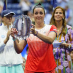 
              Ons Jabeur, of Tunisia, holds up the runner up trophy after losing to Iga Swiatek, of Poland, during the women's singles final of the U.S. Open tennis championships, Saturday, Sept. 10, 2022, in New York. (AP Photo/Matt Rourke)
            