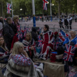 
              People camp out on The Mall on the eve of the funeral of Queen Elizabeth II in London, England, Sunday, Sept. 18, 2022. The funeral of Queen Elizabeth II, Britain's longest-reigning monarch, takes place on Monday. (AP Photo/Bernat Armangue)
            
