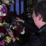 
              A woman leaves a floral arrangement, after the announcement of the death of Queen Elizabeth II, in front of Buckingham Palace in London, Thursday, Sept. 8, 2022. Queen Elizabeth II, Britain's longest-reigning monarch and a rock of stability across much of a turbulent century, died Thursday after 70 years on the throne. She was 96. (AP Photo/Alberto Pezzali)
            