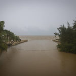 
              The mouth of the Rio Grande River reaches its banks after the passing of Hurricane Fiona in Loiza, Puerto Rico, Monday, Sept. 19, 2022. (AP Photo/Alejandro Granadillo)
            