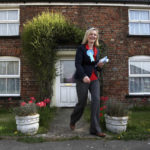 
              File - Conservative Parliamentary candidate for South West Norfolk Elizabeth Truss, canvasses in the village of West Walton, in Norfolk, during the 2010 General Election campaign, April 29, 2010.  Britain's new leader, Liz Truss, is the child of left-wing parents who grew up to be an admirer of Conservative Prime Minister Margaret Thatcher. Now she is taking the helm as prime minister herself, with a Thatcherite zeal to transform the U.K. One colleague who has known Truss since university says she is “a radical” who wants to “roll back the intervention of the state” in people’s lives, just as Thatcher once did. (Chris Radburn/PA  via AP, File)
            