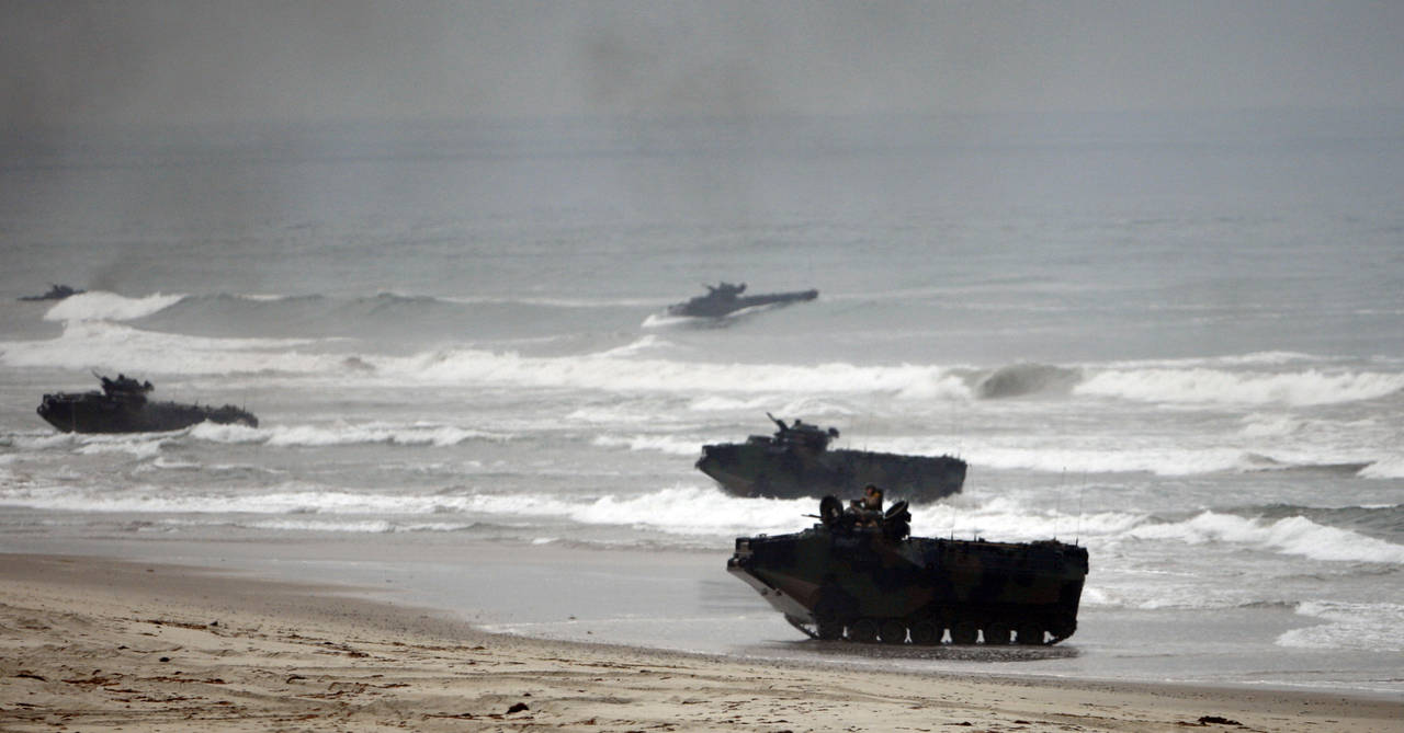 FILE - Amphibious Assault Vehicles storm Red Beach during exercises at Camp Pendleton, Calif., June...