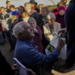 
              Locals receive food given by Ukrainian volunteers in the recently retaken village of Boguslavka village, east Ukraine, Friday, Oct. 7, 2022. Boguslavka was retaken on Oct. 3 after being occupied by Russians in April. (AP Photo/Francisco Seco)
            