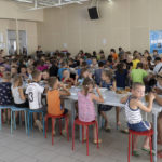 
              Children from different orphanages from the Donetsk region, eat a meal at a camp in Zolotaya Kosa, the settlement on the Sea of Azov, Rostov region, southwestern Russia, Friday, July 8, 2022. Russia's open effort to adopt Ukrainian children and bring them up as Russian is emerging as one of the most explosive issues of the war. (AP Photo)
            