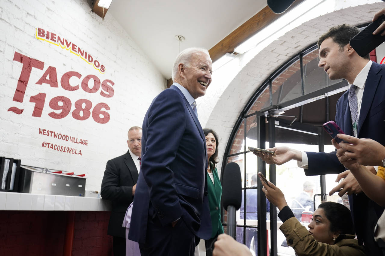 President Joe Biden answers questions from members of the media as he leaves Tacos 1986, a Mexican ...