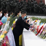 
              Citizens lay bouquets of flowers before the statues of North Korea leaders Kim Il Sung and Kim Jong Il on the occasion of the 77th founding anniversary of the Worker's Party of Korea in Pyongyang, North Korea, Monday, Oct. 10, 2022. (AP Photo/Cha Song Ho)
            