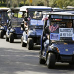 A caravan of golf carts head to a polling place to take part in early voting after a campaign event for Rep. Val Demings, D-Fla., candidate for U.S. Senate, Monday, Oct. 17, 2022, in The Villages, Fla. (AP Photo/John Raoux)