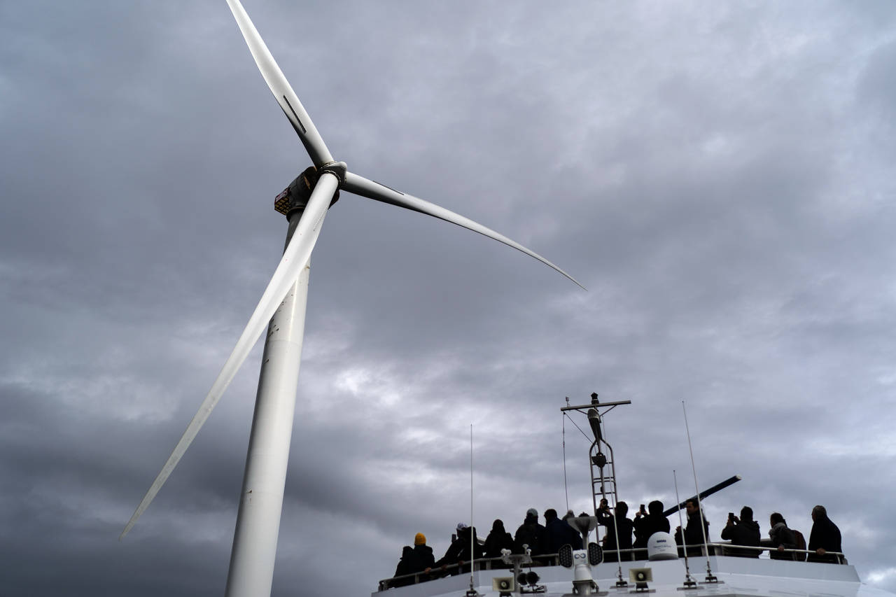FILE Guests tour one of the turbines of America's first offshore wind farm, owned by the Danish com...