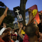 
              A supporter of Brazil's former President Luiz Inacio Lula da Silva, who is running for president again, holds a coffin-shaped poster board with an image of incumbent President Jair Bolsonaro, after polls closed in the country's presidential run-off election, in Sao Paulo, Brazil, Sunday, Oct. 30, 2022. (AP Photo/Matias Delacroix)
            