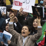 Sima Mohair, foreground center, participates in a rally calling for regime change in Iran following the death of Mahsa Amini, a young woman who died after being arrested in Tehran by Iran's notorious "morality police," in Washington, Saturday, Oct. 1, 2022. (AP Photo/Cliff Owen)