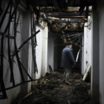 
              An Orthodox priest walks through the destroyed Holy Mountains Lavra of the Holy Dormition in the liberated town of Sviatohirsk, Donetsk region, Ukraine, Saturday, Oct. 29, 2022. (AP Photo/Andriy Andriyenko)
            