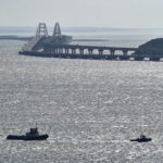 
              A helicopter flies to drop water to stop fire on Crimean Bridge connecting Russian mainland and Crimean peninsula over the Kerch Strait, in Kerch, Crimea, Saturday, Oct. 8, 2022. Russian authorities say a truck bomb has caused a fire and the collapse of a section of a bridge linking Russia-annexed Crimea with Russia. The bridge is a key supply artery for Moscow's faltering war effort in southern Ukraine. (AP Photo)
            