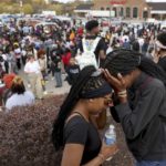 
              Students stand in a parking lot near the Central Visual & Performing Arts High School after a reported shooting at the school in St. Louis on Monday, Oct. 24, 2022. (David Carson/St. Louis Post-Dispatch via AP)
            