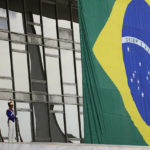 
              Soldiers stand guard next to a Brazilian flag on the ramp at the Planalto Palace in Brasilia, Brazil, Monday, Oct. 31, 2022, the morning after the re-election of former Brazilian President Luiz Inacio Lula da Silva. (AP Photo/Eraldo Peres)
            