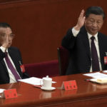 
              Chinese Premier Li Keqiang, left, and President Xi Jinping raise their hands to vote at the closing ceremony of the 20th National Congress of China's ruling Communist Party at the Great Hall of the People in Beijing, Saturday, Oct. 22, 2022. Li, the nation's No. 2 official and a chief proponent of economic reforms, is among four of the seven members of the nation's all-powerful Politburo Standing Committee who will not be reappointed in a leadership shuffle Sunday. (AP Photo/Andy Wong)
            