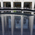 The newly renovated David Geffen Hall is reflected in the Revson Fountain, Thursday, Aug. 25, 2022, at the Lincoln Center for the Performing Arts in New York. After a $550 million renovation that took two years, the New York Philharmonic returns to David Geffen Hall for a series of openings beginning with a Thursday night ribbon-cutting, a Friday performance for construction workers and Saturday afternoon and evening community concerts. (AP Photo/Mary Altaffer)