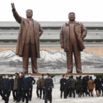
              Citizens visit the bronze statues of North Korea leaders Kim Il Sung and Kim Jong Il on Mansu Hill on the occasion of the 77th founding anniversary of the Worker's Party of Korea in Pyongyang, North Korea, Monday, Oct. 10, 2022. (AP Photo/Jon Chol Jin)
            