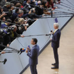 
              From left, Spain's Prime Minister Pedro Sanchez, Latvia's Prime Minister Krisjanis Karins and Germany's Chancellor Olaf Scholz speak with the media as they arrives for an EU summit at the EU Council building in Brussels, Thursday, Oct. 20, 2022. European Union leaders were heading into a two-day summit Thursday with opposing views on whether, and how, the bloc could impose a gas price cap to contain the energy crisis fueled by Russian President Vladimir Putin's invasion of Ukraine and his strategy to choke off gas supplies to the bloc at will. (AP Photo/Olivier Matthys)
            