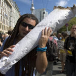 
              FILE - A protestor holds a mock joint during the so-called hemp parade demanding the legalization of cannabis in Berlin, Aug. 1, 2009. Germany's health minister has unveiled plans to decriminalize the possession of up to 30 grams of cannabis and allow the sale of the substance to adults for recreational purposes. (AP Photo/Maya Hitij, File)
            