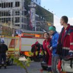 
              An injured man receives medical treatment at the scene of Russian shelling, in Kyiv, Ukraine, Monday, Oct. 10, 2022. Multiple explosions rocked Kyiv early Monday following months of relative calm in the Ukrainian capital. Kyiv Mayor Vitali Klitschko reported explosions in the city's Shevchenko district, a large area in the center of Kyiv that includes the historic old town as well as several government offices. (AP Photo/Efrem Lukatsky)
            