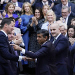 
              Rishi Sunak, centre, gestures as conservative MPs greet him after arriving at the Conservative Party leadership contest at the Conservative party Headquarters in London, Monday, Oct. 24, 2022. Rishi Sunak will become the next Prime Minister after winning the Conservative Party leadership contest.(AP Photo/Aberto Pezzali)
            