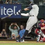 
              New York Yankees' Aaron Judge hits a solo home run, his 62nd of the season, during the first inning in the second baseball game of a doubleheader against the Texas Rangers in Arlington, Texas, Tuesday, Oct. 4, 2022. With the home run, Judge set the AL record for home runs in a season, passing Roger Maris. (AP Photo/LM Otero)
            