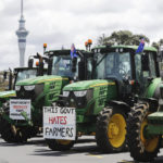 
              New Zealand farmers protest in central Auckland on government plans to make them pay for greenhouse gas emissions, Thursday, Oct. 20, 2022. New Zealand farmers drove their tractors to towns around New Zealand on Thursday in protest at a proposed new tax on cow burps and other farm greenhouse gas emissions. (Dean Purcell/New Zealand Herald via AP)
            