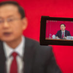 
              Spokesperson Sun Yeli is seen on a video screen as he speaks via video link during a press conference held on the eve of the opening session of the 20th National Congress of China's ruling Communist Party in Beijing, Saturday, Oct. 15, 2022. At a two-hour news conference Saturday, the congress' spokesperson Sun Yeli reaffirmed the government's commitment to its "zero-COVID" policy, despite the economic costs, and repeated its threat to use force to annex self-governing Taiwan. (AP Photo/Mark Schiefelbein)
            
