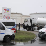 
              A tanker arrives as police officers and riot police officer guard an access to the TotalEnergies oil depot, Thursday, Oct.13, 2022 outside Dunkirk, northern France. French President Emmanuel Macron promised the situation in the country's gas stations will soon be back to "normal" as the government started requisitioning some workers at ExxonMobil's Esso gas stations amid an ongoing strike that is making life difficult for French drivers. The government is considering making a similar decision soon regarding Total facilities, depending on the outcome of salary negotiations . (AP Photo/Michel Spingler)
            