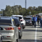
              Cars queue for the ferry connecting Crimean peninsula and Russia at the Kerch Strait, in Kerch, Crimea, Saturday, Oct. 8, 2022. An explosion caused the partial collapse of a bridge linking the Crimean Peninsula with Russia on Saturday, damaging a key supply artery for the Kremlin's faltering war effort in southern Ukraine. Russian authorities said a truck bomb caused the blast and that three people were killed. (AP Photo)
            