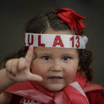 
              A girl signs an "L" for Lula, during a campaign rally for Brazil's former President Luiz Inacio Lula da Silva, who is running for president again, in Belo Horizonte, Brazil, Saturday, Oct. 22, 2022. Da Silva will face incumbent President Jair Bolsonaro in a presidential runoff on Oct. 30. (AP Photo/Thomas Santos)
            