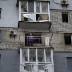 
              A man on his balcony looks out of his apartment hit by a Russian missile in Mykolaiv, Sunday, Oct. 23, 2022. (AP Photo/Emilio Morenatti)
            