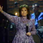 FILE - Loretta Lynn waves to the crowd after performing during the Americana Music Honors and Awards show Wednesday, Sept. 17, 2014, in Nashville, Tenn. Lynn, the Kentucky coal miner's daughter who became a pillar of country music, died Tuesday at her home in Hurricane Mills, Tenn. She was 90. (AP Photo/Mark Zaleski, File)